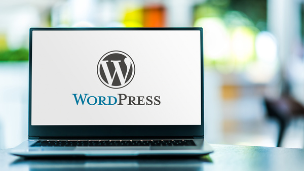 Laptop computer displaying logo of WordPress - Wordpress hosting concept